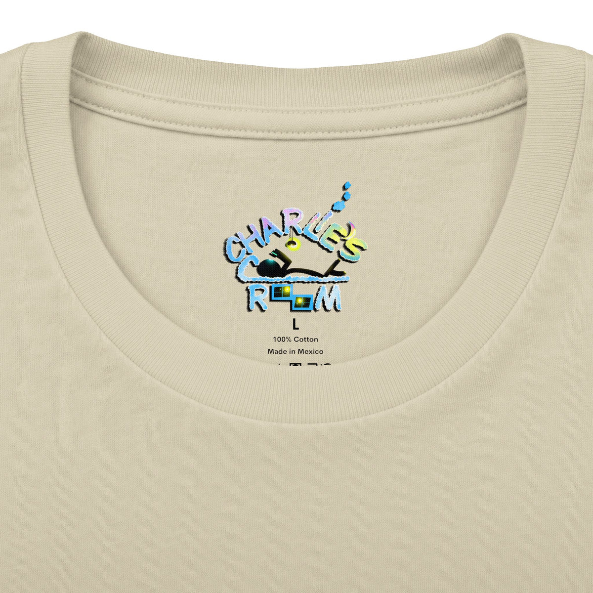 Close-up of a cream-colored t-shirt neck label featuring a colorful graphic that reads 'CHARLIE'S COZY ROOM' with a crown and small text below reading '100% Cotton Made in Mexico'.