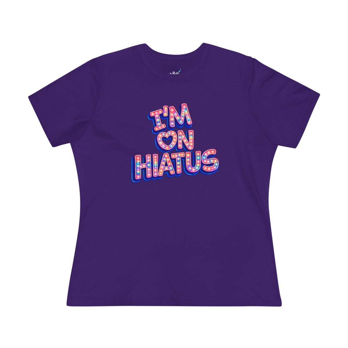 A purple short-sleeve t-shirt with a graphic on the front that reads 'I'M ON HIATUS' in a red, white, pink, and blue patterned font, displayed on a solid white background.